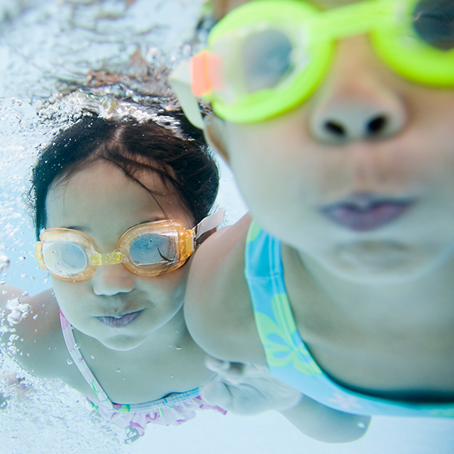 Photo of active children swimming