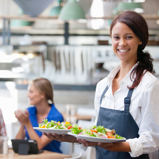 Woman serving healthy food at restaurant